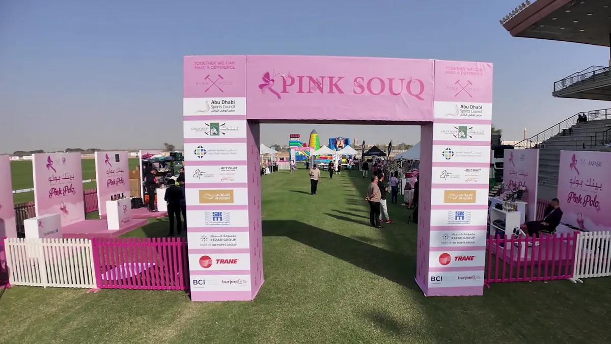 Pink Souq entrance arch with sponsor panels at the Pink Polo Event 2025, Ghantoot Racing & Polo Club, Abu Dhabi