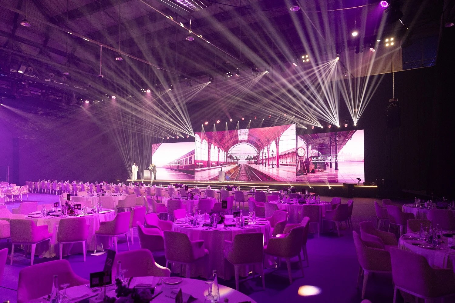 Guests seated across the ballroom under moving beam lights during the Shjseen ceremony