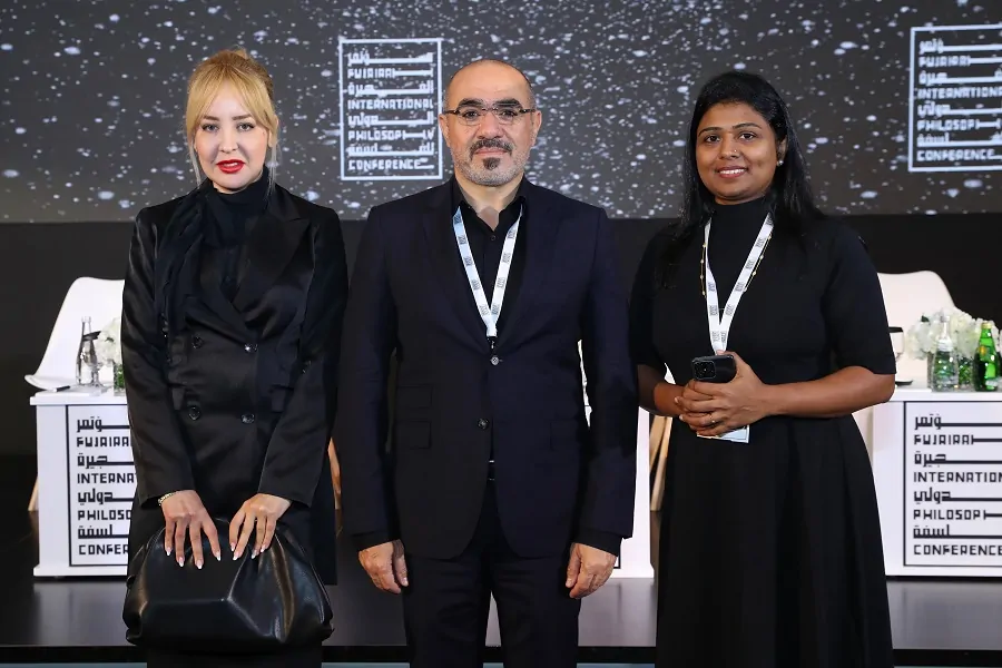 Speakers on stage in front of conference branding at the Fujairah International Philosophy Conference 2022