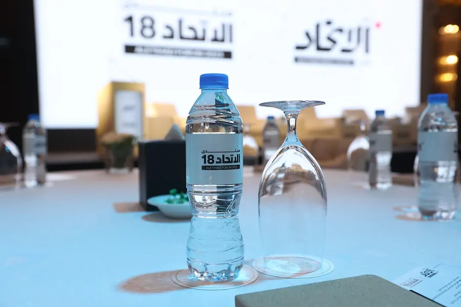 Aletihad Forum 18 branded water bottle on a guest table at the forum in Abu Dhabi 2023