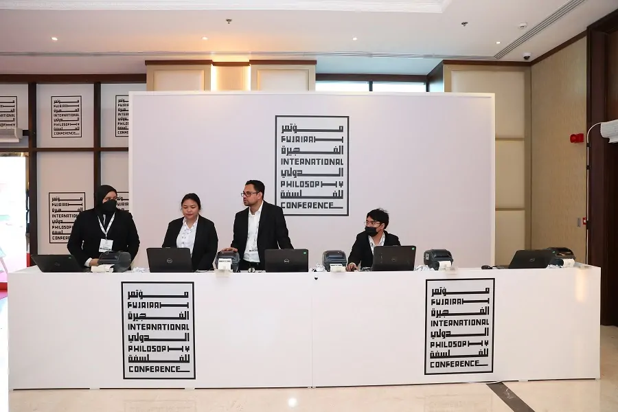 Branded registration desk with hospitality staff at the Fujairah International Philosophy Conference 2022