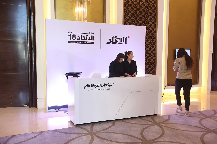 Registration desk with Aletihad Forum branding welcoming guests in Abu Dhabi 2023