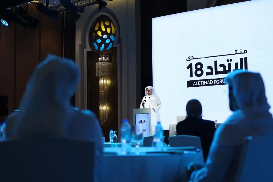 Speaker at the lectern beside the 18th Aletihad Forum LED screen, Abu Dhabi 2023