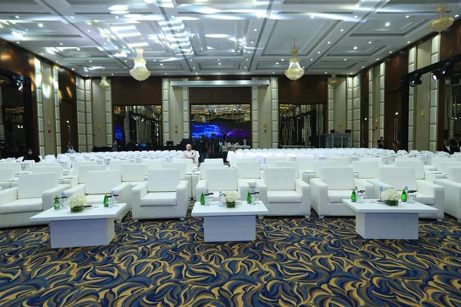 Ballroom set with white lounge seating and coffee tables for the Fujairah International Philosophy Conference