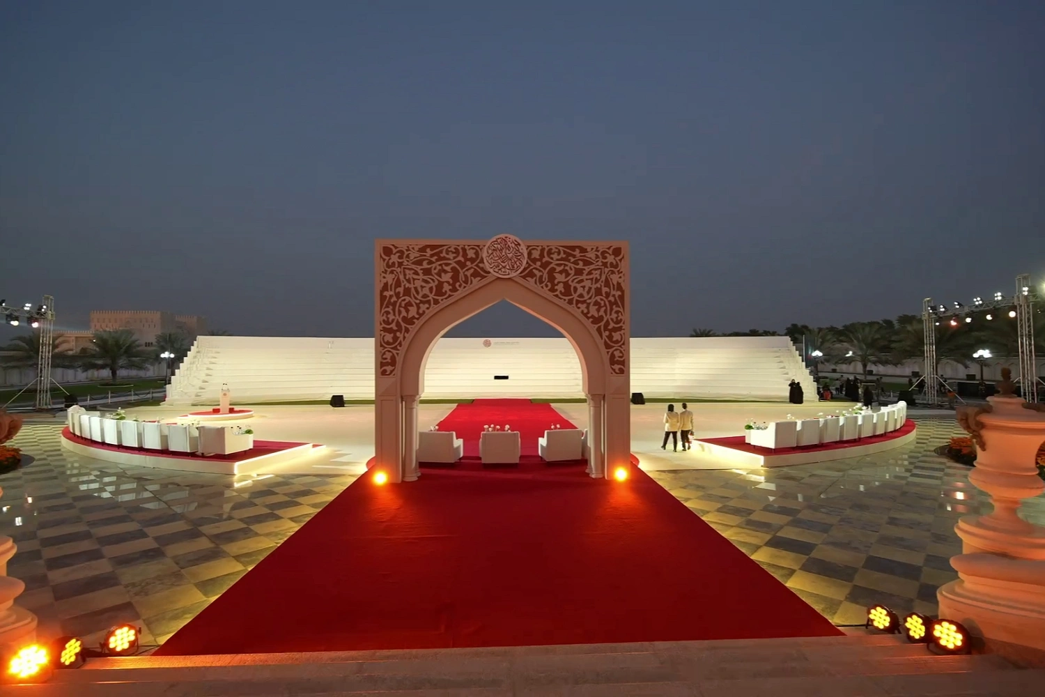 Traditional Arabic entrance archway and red carpet lit at night for the Sheikh Sultan Awards 2025, Sharjah