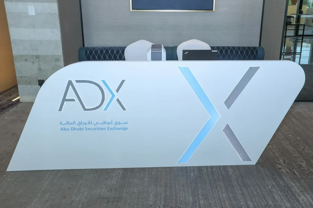 Branded ADX registration counter with signature X design at the Abu Dhabi Securities Exchange Conference 2024