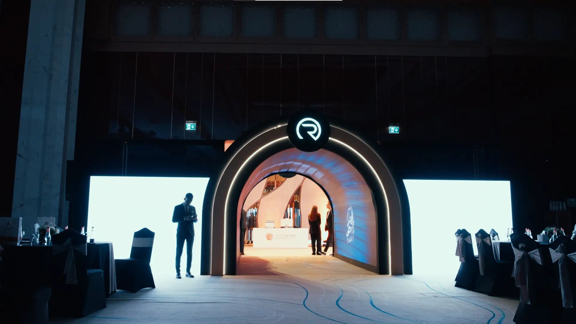 Illuminated LED tunnel entrance with the Al Rasikhoon logo at the Al Rasikhoon Real Estate launch 2025, Ajman