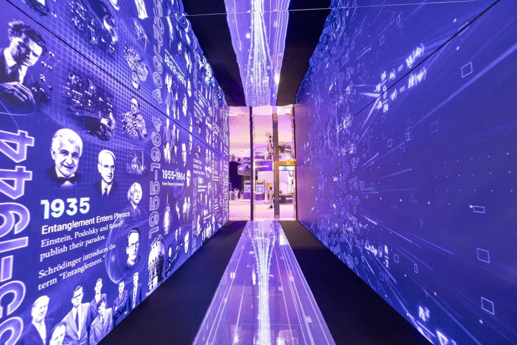 Immersive LED tunnel for the Technology Innovation Institute showing a timeline of physics and famous scientists
