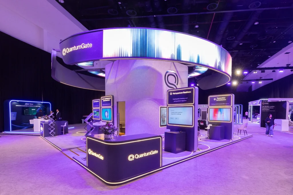 Custom Quantinuum booth with LED ring canopy and demo stations on the exhibition floor