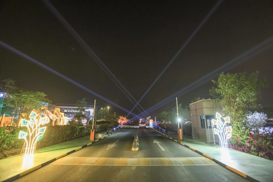Illuminated light sculptures and beam lights along the approach road to the Shams Creative Festival 2025