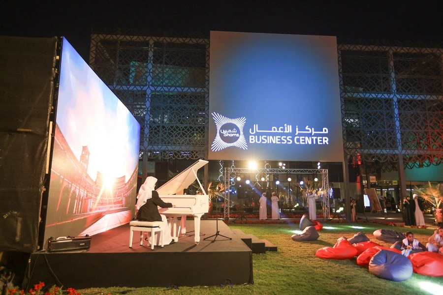 Grand piano performance on stage beside a large LED screen at the Shams Creative Festival 2025, Sharjah Media City