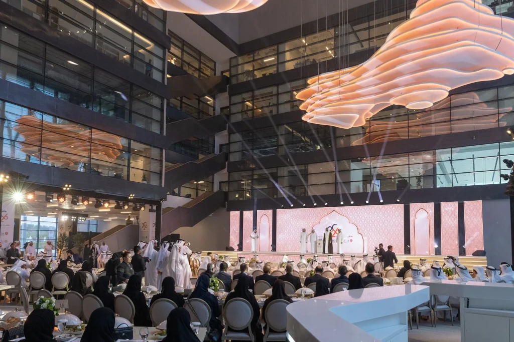 Full audience at banquet tables facing the main stage during the Partners of Excellence Forum programme