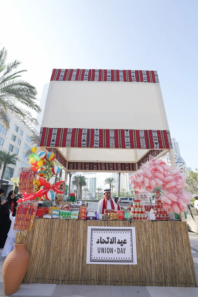 Union Day kiosk with candy floss and traditional sweets under a Sadu canopy at the 52nd National Day event, Dubai World Trade Centre