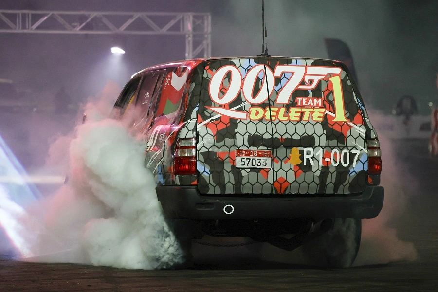 Branded rally car performing a burnout with tyre smoke at Yuka Drive Fest Gymkhana 2025, Al Ain