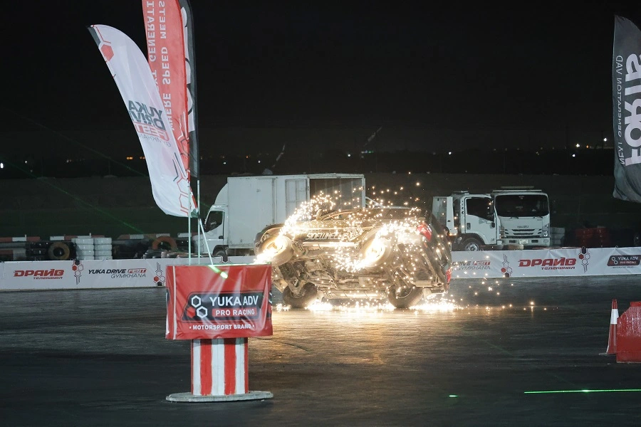 LED-lit car spinning in a shower of sparks in the arena at Yuka Drive Fest Gymkhana 2025, Al Ain
