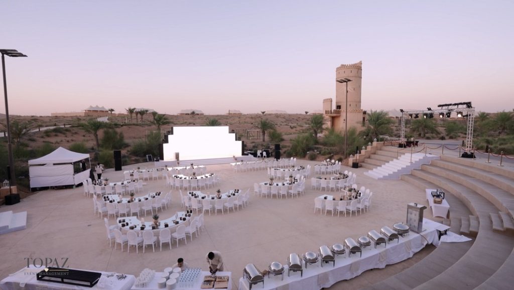 Open-air banquet setup with round tables and stage at the Sharjah Chamber of Commerce & Industry Annual Ceremony 2024, Sharjah