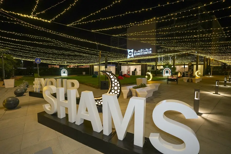 Illuminated #YourShams letters and crescent under a canopy of fairy lights at the Shams Ramadan Festival 2024, Sharjah
