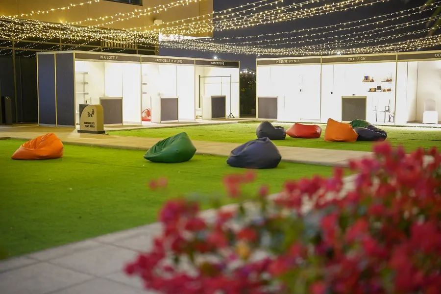 Bean bag seating on the lawn in front of white souq stalls at the Shams Ramadan Festival 2024