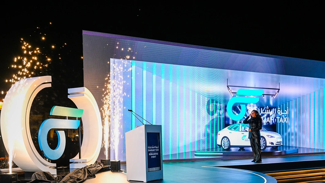 Giant illuminated Sharjah Taxi logo sculpture and cold sparks on the LED stage at the new logo launch 2023, by Topaz Events