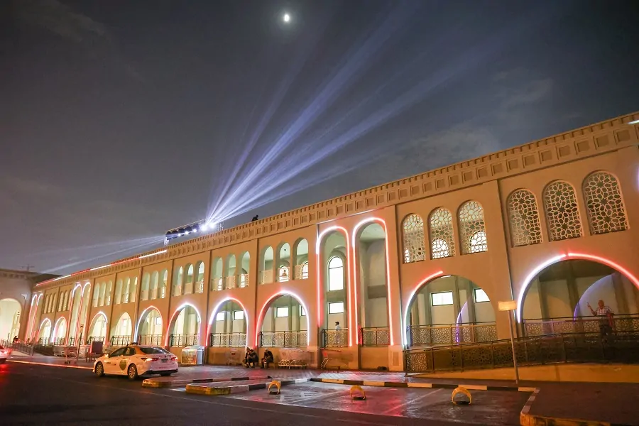 Souq Al Jubail building with sky-beam lights at night during Sharjah Asset Management’s 15th Anniversary