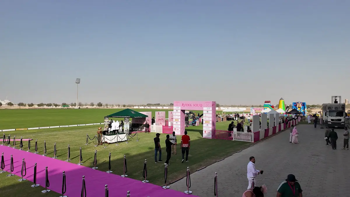 Decorative pink floral archway welcoming guests to the Pink Polo 2025 breast cancer awareness event in Abu Dhabi