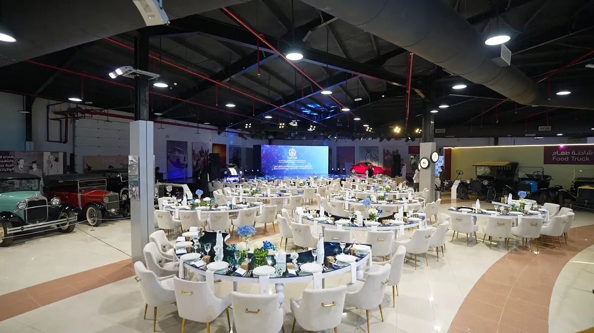 The Sharjah Classic Cars Museum venue transformed by Topaz Events with professional stage lighting and premium event seating.
