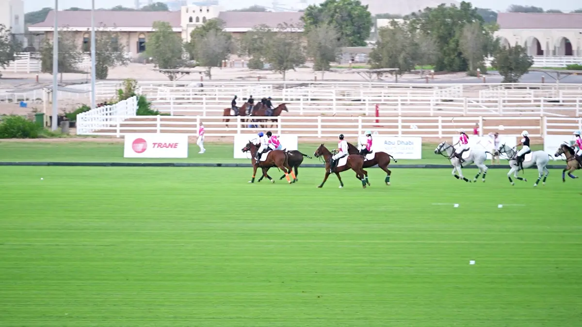 Professional polo players competing at the Pink Polo 2025 event for breast cancer awareness.