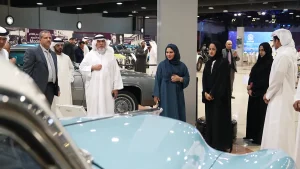 Senior guests and VIP attendees admiring vintage automobiles during a guided tour at the Sharjah Classic Cars Museum event production.