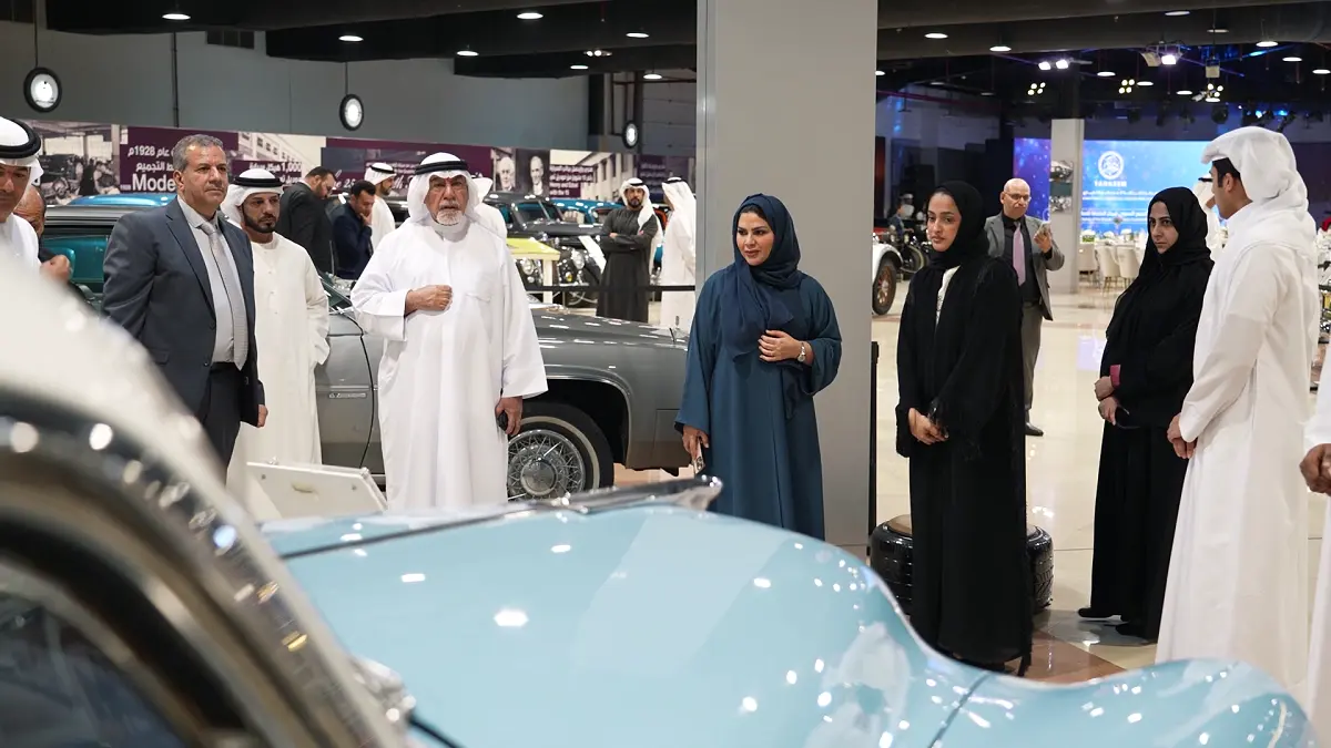 Senior guests and VIP attendees admiring vintage automobiles during a guided tour at the Sharjah Classic Cars Museum event production.