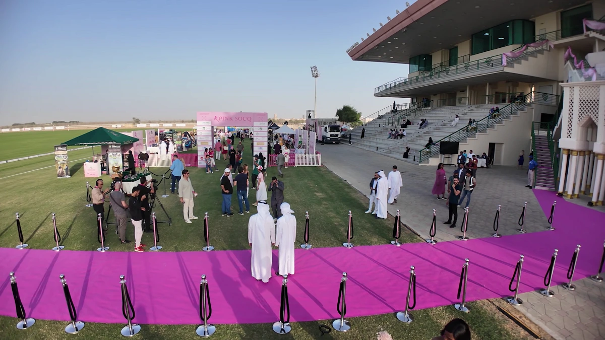 Aerial view of the pink-themed venue setup overlooking the polo field in Abu Dhabi.