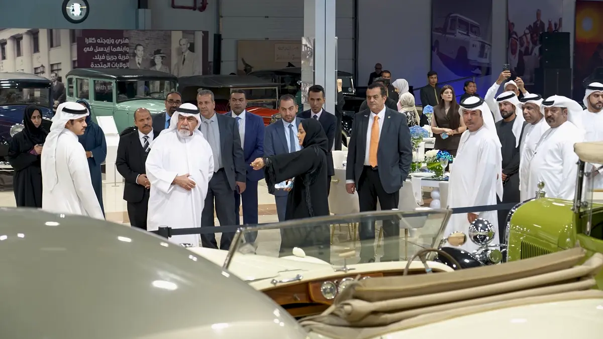 VIP guests and classic car enthusiasts engaging with the heritage display under professional event lighting at the Sharjah Classic Cars Museum.