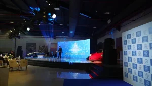 Vintage classic cars showcased under professional spotlights and architectural lighting at the Sharjah Classic Cars Museum.