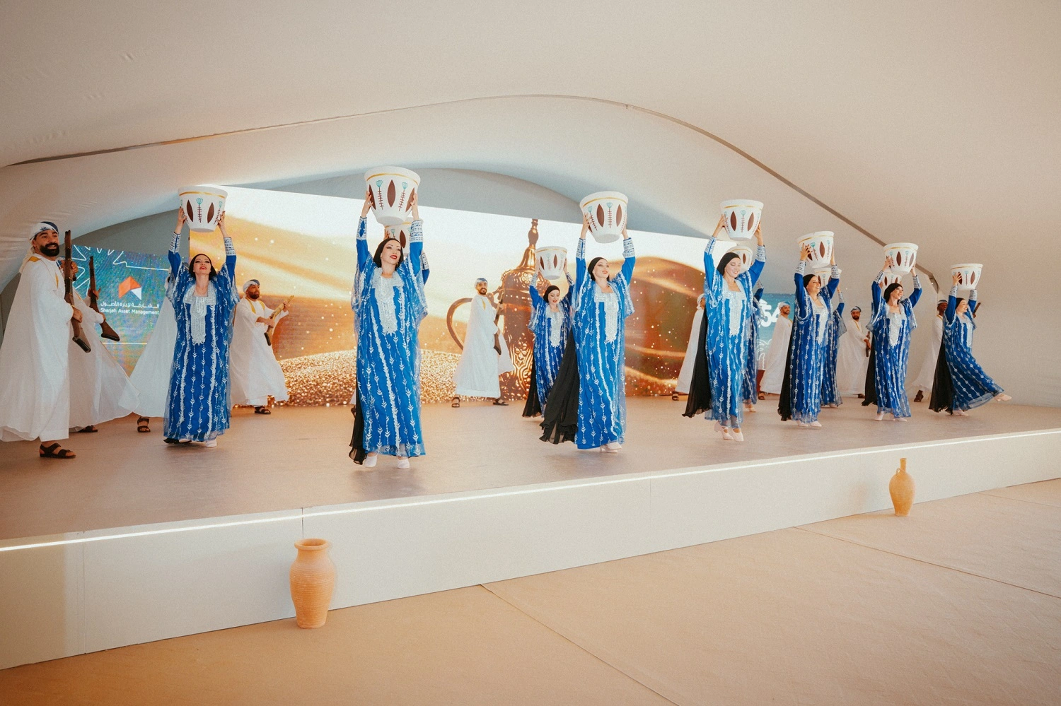 Topaz Events organizing the 54th UAE National Day celebration for Sharjah Asset Management, featuring patriotic décor, stage setup, LED screens, and cultural performances.