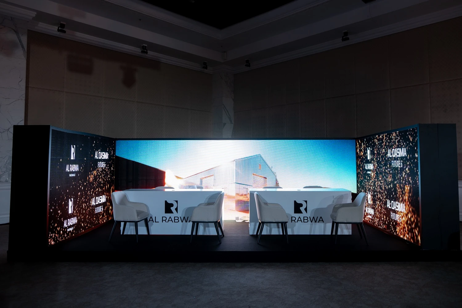 High-end corporate event furniture including comfortable armchairs and elegant table arrangements.