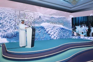 High-resolution LED screen on the main stage presenting Dusit Thani Residences during Aqaar Property Developments launch event.