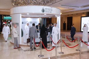 The main registration desk at the SNOC HSE Expo 2026 exhibition stand, Al Jawaher, Sharjah — featuring a sleek, branded curved counter design that served as the central welcome point for visitors, delivered as part of Topaz Events' complete stand setup and execution.
