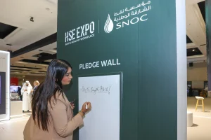 A branded Pledge Wall installation at the SNOC exhibition stand during HSE Expo 2026, Al Jawaher, Sharjah, inviting visitors to make a personal commitment to health, safety, and environmental values — part of Topaz Events' full interactive stand experience.