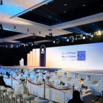 Large stage with LED screen and podium by Topaz Events for the 2025 Sharjah Census Reveal, with guests seated and attending the event at Al Jawaher Convention Centre, Sharjah