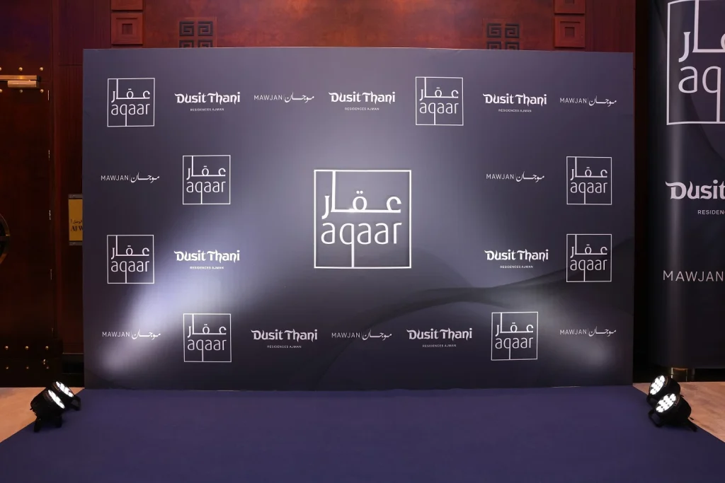 Aqaar and Dusit Thani branded step-and-repeat media wall with floor lighting