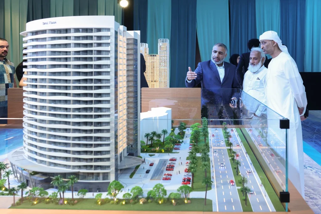 VIP guests viewing the Dusit Thani Residences tower model at the Aqaar Property Launch Event