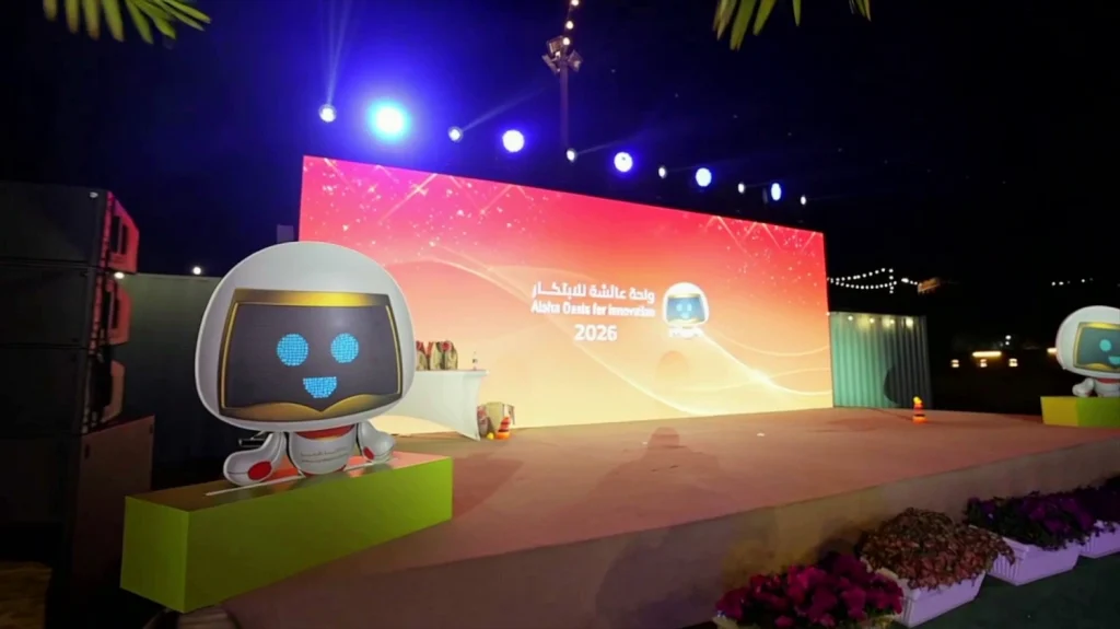 Aisha Oasis for Innovation 2026 outdoor stage with LED backdrop and robot mascot, produced by Topaz Events in Sharjah