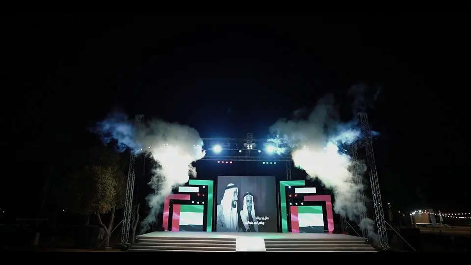 LED stage with UAE flag-themed panels, truss lighting and smoke effects at the 53rd Eid Al Etihad celebrations, Sharjah National Park