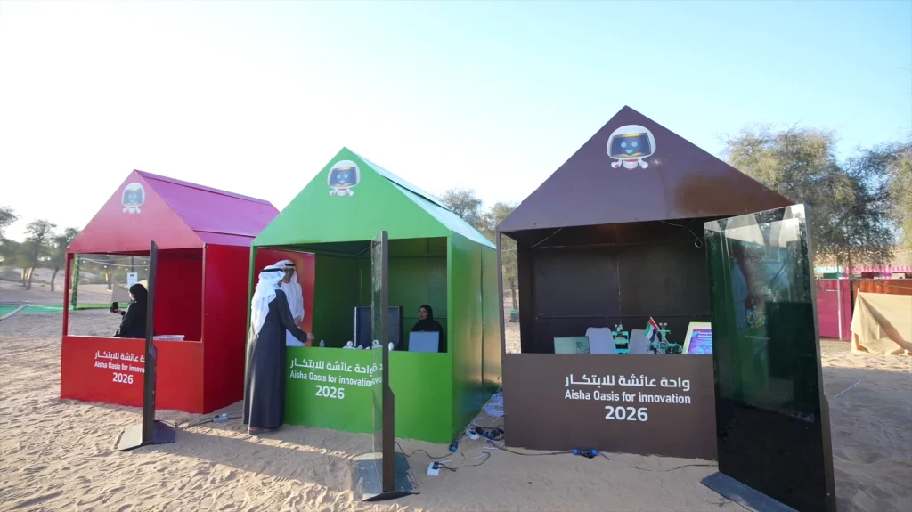 Branded exhibition booths at the Aisha Oasis for Innovation 2026 festival in the Sharjah desert