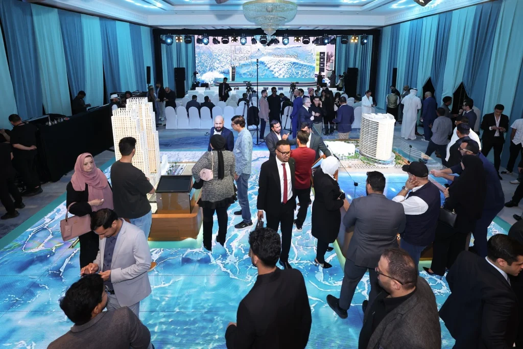 Guests networking around architectural models on an LED floor at the Aqaar Dusit Thani Residences launch