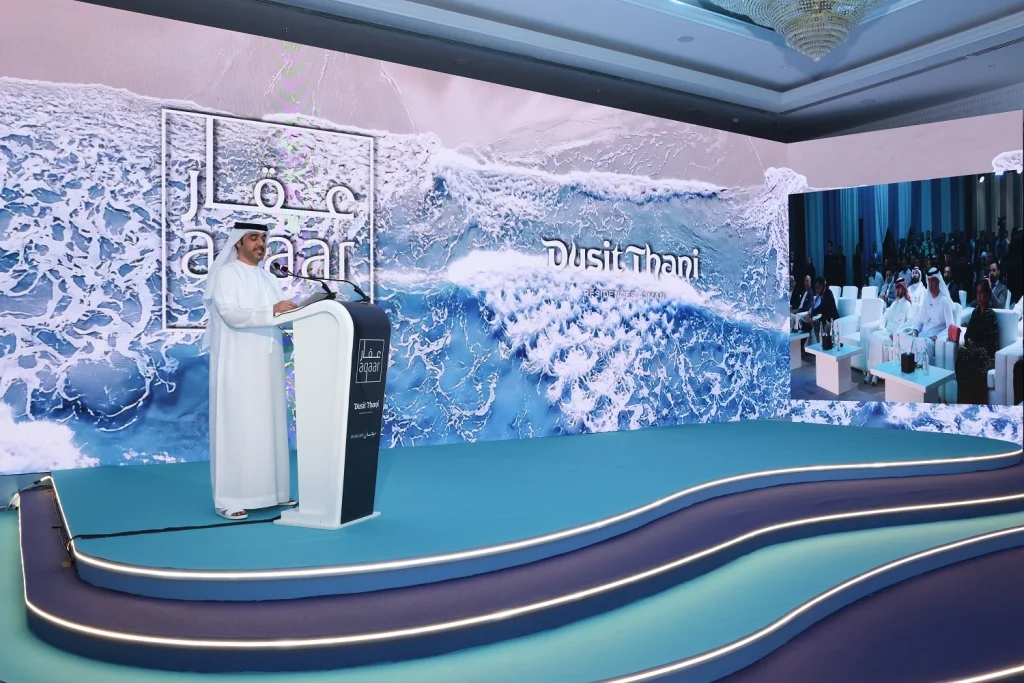 Aqaar Developments keynote at the podium in front of the panoramic LED wall — play the Aqaar Property Launch Event video