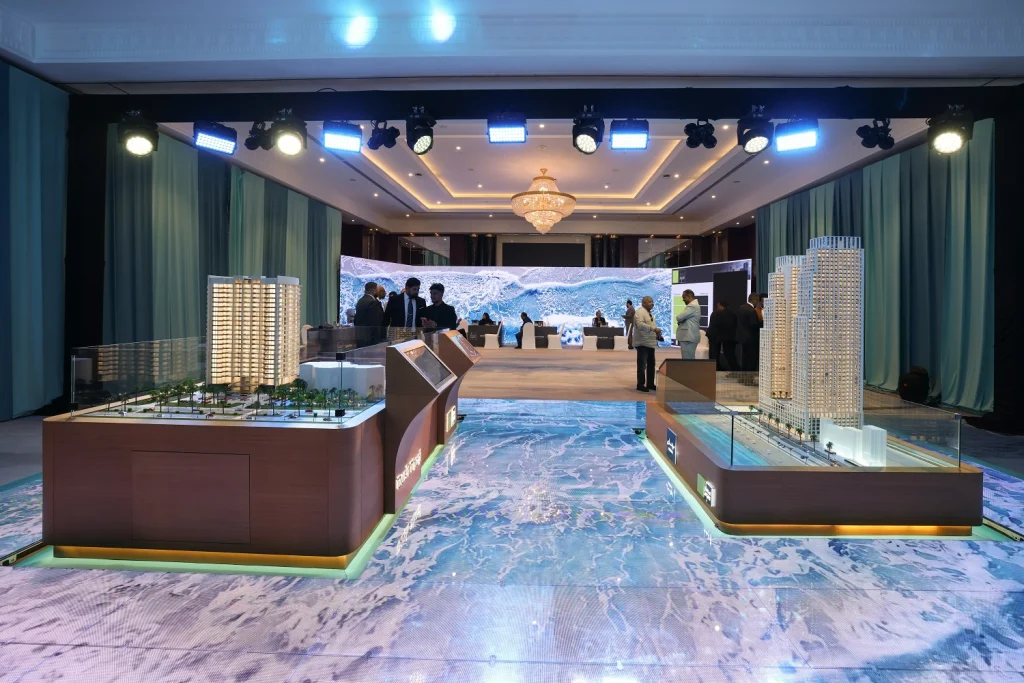Dusit Thani Residences Ajman scale models on illuminated display plinths at the Aqaar launch event
