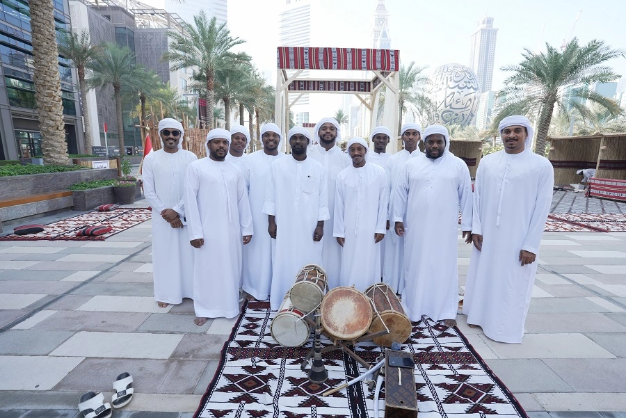 Emirati folk band in white kanduras with traditional drums at the 52nd UAE National Day heritage village for Dubai World Trade Centre, by Topaz Events
