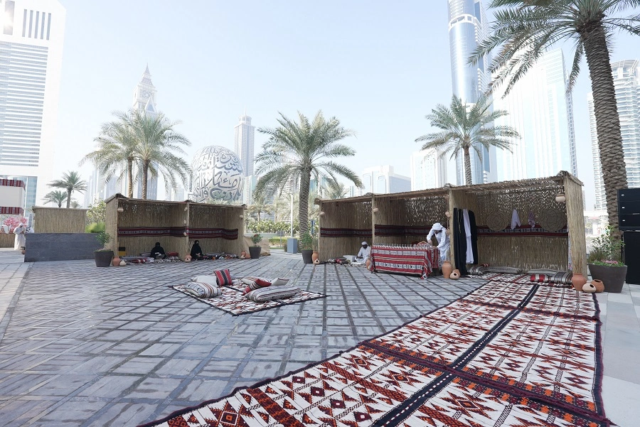 Emirati heritage village with barasti booths and Sadu carpets beside the Museum of the Future at the DWTC 52nd National Day event